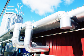 Image showing Industrial zone, Steel pipelines and valves against blue sky