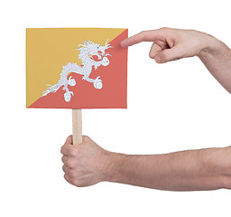 Image showing Hand holding small card - Flag of Bhutan