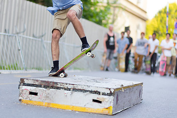 Image showing Boys skateboarding on street. Urban life.