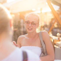 Image showing Female friends enjoying a conversation on market.