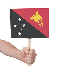 Image showing Hand holding small card - Flag of Papua New Guinea