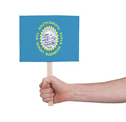 Image showing Hand holding small card - Flag of South Dakota