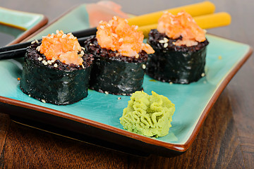 Image showing Baked sushi rolls served on blue plate