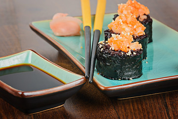 Image showing Sushi rolls served on blue plate