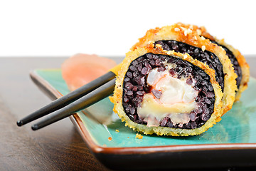Image showing Baked sushi rolls served on turquoise plate