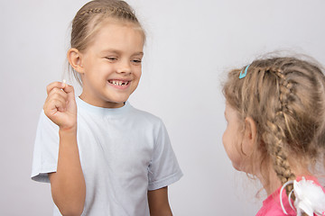 Image showing Girl shows her the other girl had fallen front baby tooth