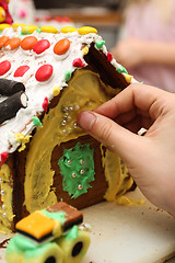 Image showing Decorating gingerbread house