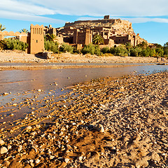 Image showing sunset in africa old construction near the river blue