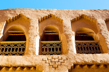 Image showing   yellow window in   construction and brown wall  