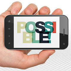 Image showing Business concept: Hand Holding Smartphone with Possible! on  display