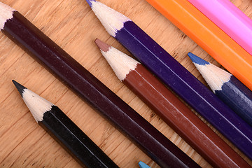 Image showing Frame of old Colour pencils on Old wooden plate texture background