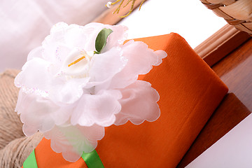 Image showing Christmas gift box and empty wooden frame on wooden table