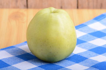 Image showing Fresh green apple on blue material backgound
