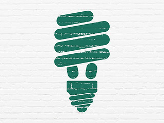 Image showing Finance concept: Energy Saving Lamp on wall background