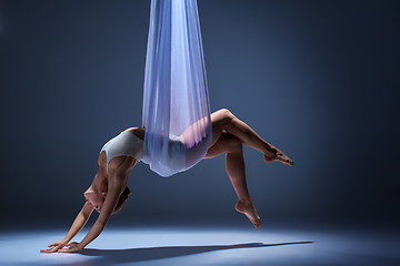 Image showing Young beautiful dancer in beige dress posing on gray background