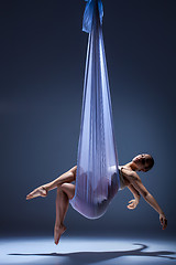 Image showing Young beautiful dancer in beige dress posing on gray background