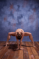 Image showing Young beautiful dancer in beige swimwear dancing on lilac background