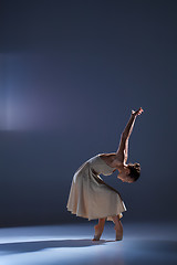 Image showing Young beautiful dancer in beige dress dancing on gray background