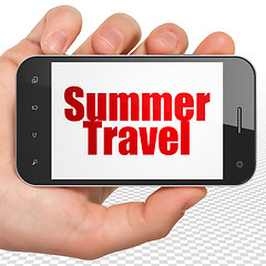 Image showing Travel concept: Hand Holding Smartphone with Summer Travel on display