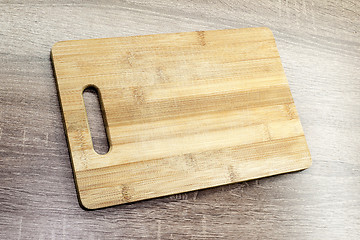 Image showing old wooden cutting board on the table