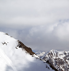Image showing Snowy slope and sky with clouds at sun day