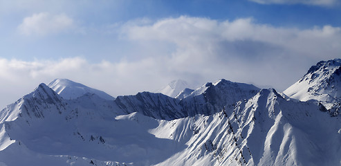 Image showing Panoramic view on snowy mountains in clouds