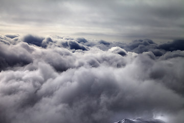 Image showing Top of off-piste slope in storm clouds