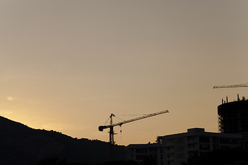 Image showing construction cranes at sunset  