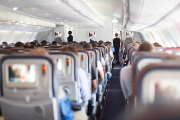 Image showing Interior of airplane with passengers on seats.