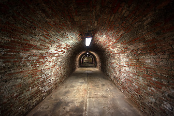 Image showing Long underground brick tunnel angle shot