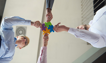 Image showing business people group assembling jigsaw puzzle