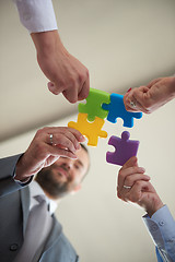 Image showing business people group assembling jigsaw puzzle