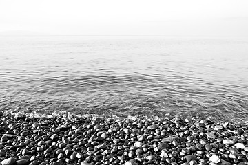 Image showing stone in the coastline sunrise and light ocean white sky