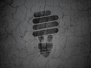 Image showing Finance concept: Energy Saving Lamp on grunge wall background