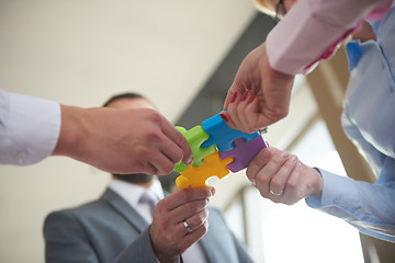 Image showing business people group assembling jigsaw puzzle