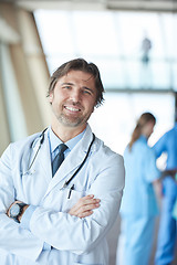 Image showing group of medical staff at hospital, handsome doctor in front of 