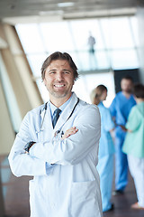 Image showing group of medical staff at hospital, handsome doctor in front of 