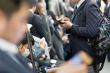 Image showing Business people traveling by Tokyo metro.