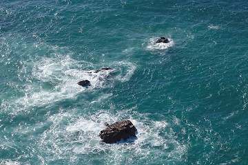 Image showing Waves breaking on rocks in sea