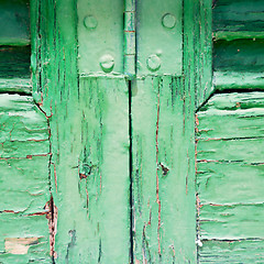 Image showing in the old wall a hinged window green wood and rusty metal
