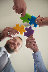 Image showing business people group assembling jigsaw puzzle