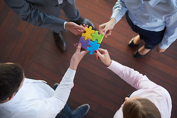 Image showing business people group assembling jigsaw puzzle