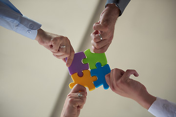 Image showing business people group assembling jigsaw puzzle