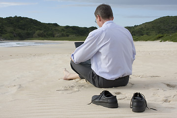 Image showing Businessman with laptop on the beach