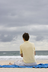 Image showing Woman sitting on the beach