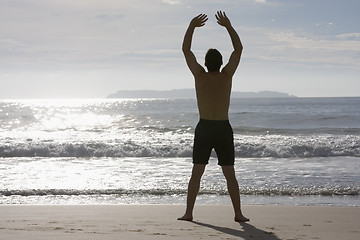 Image showing Man doing yoga on the beach