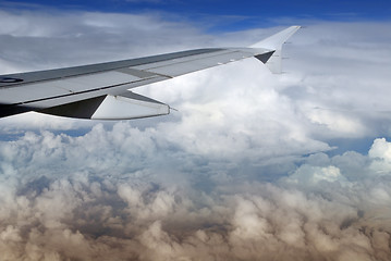 Image showing Airplane wing over cloudscape