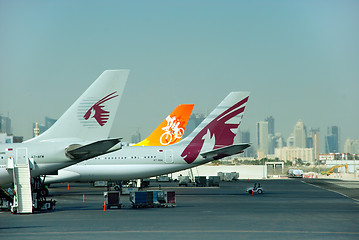 Image showing Qatar airplane tails and city skyline