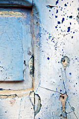 Image showing dirty stripped  in the blue  door and rusty  