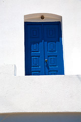 Image showing blue door in village santorini greece    white wall